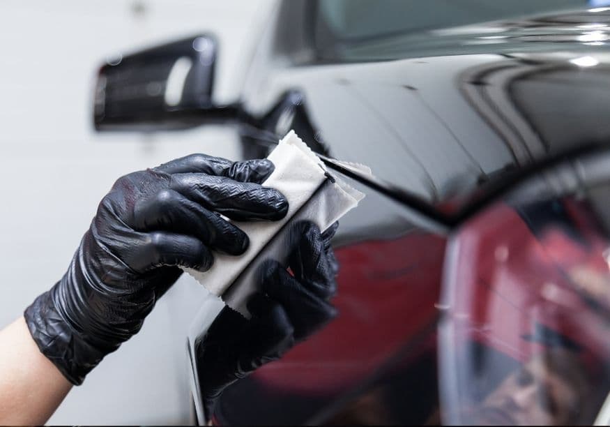 Ceramic coating being applied to a glossy black panel, ceramic coating vs wax vs sealant in Vancouver