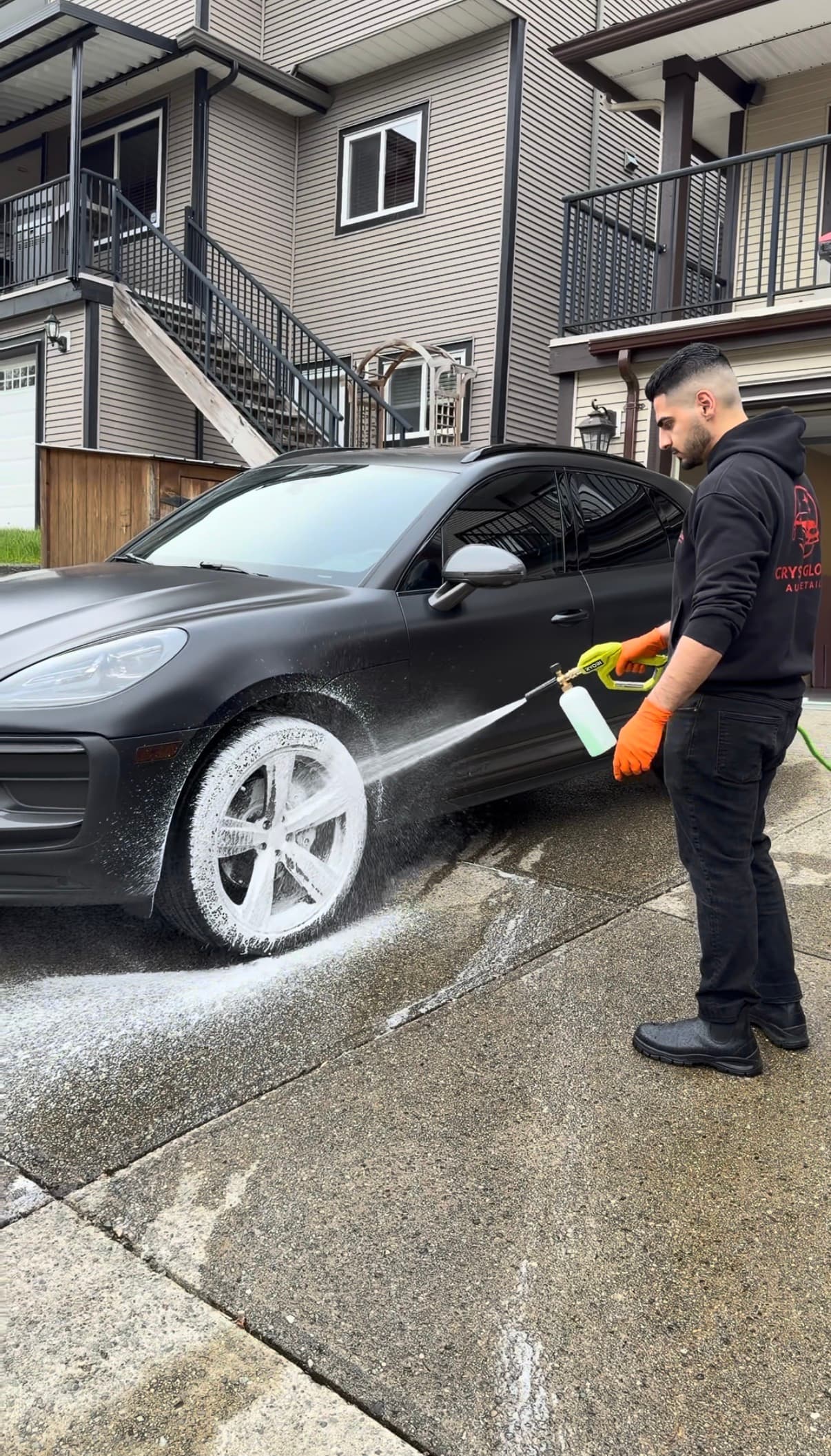 Crystal Gloss owner detailing a black Porsche