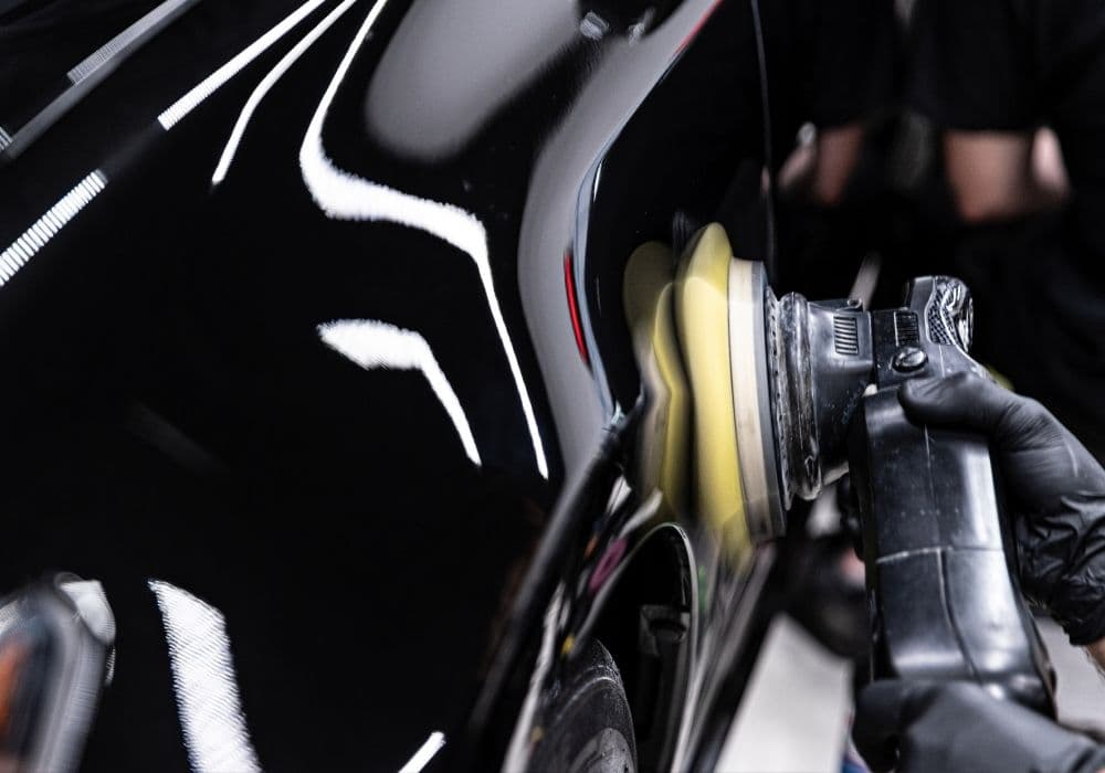 Machine polishing swirl marks out of black car paint — paint correction in Vancouver
